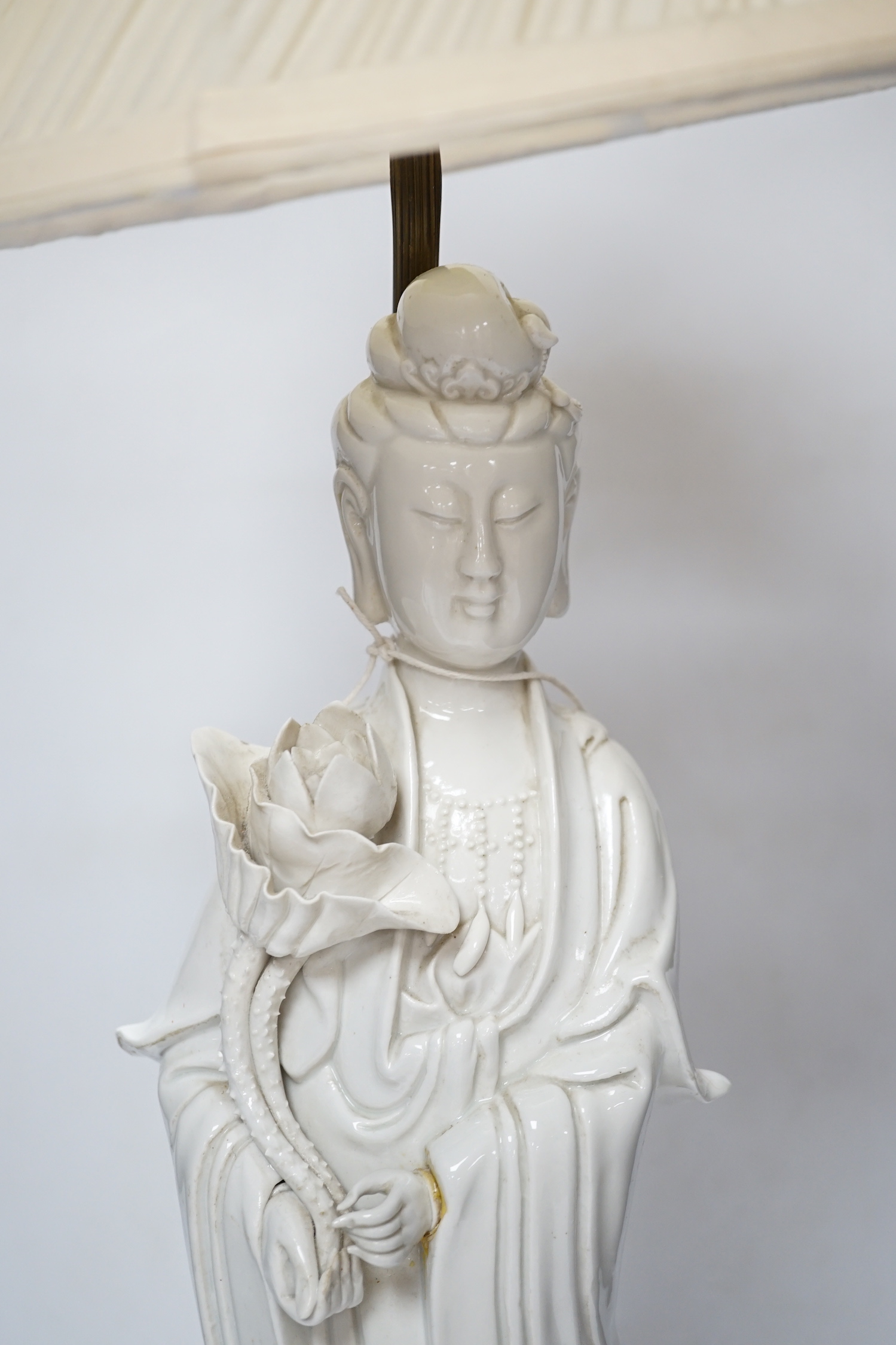 A Chinese blanc de chine figure of Guanyin, mounted as a lamp, 71cm with shade